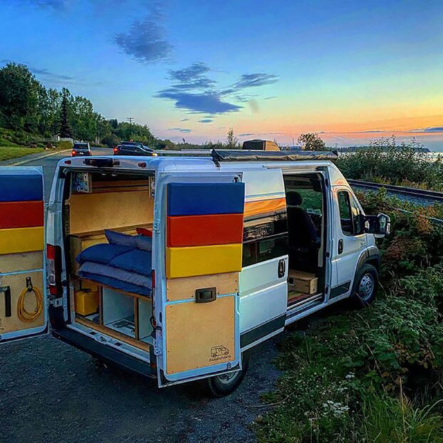 Travel Van Parked in Front of Beach at Sunset