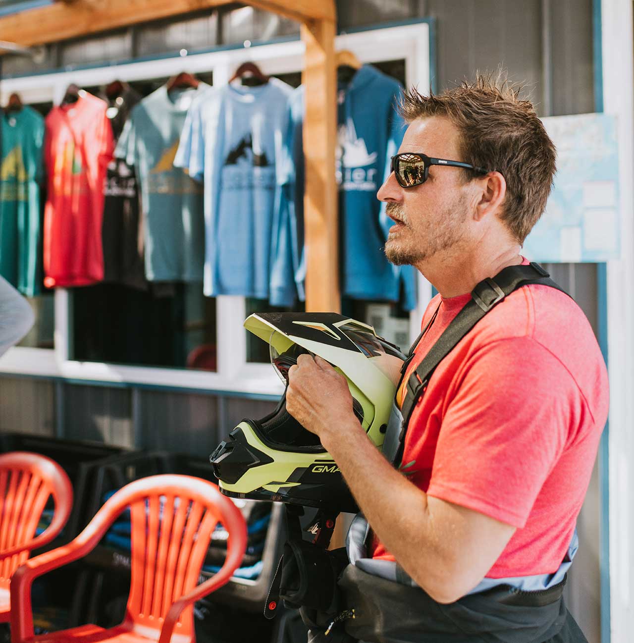 Jetski Tour Instructor Giving Speech about Safety while Holding Helmet