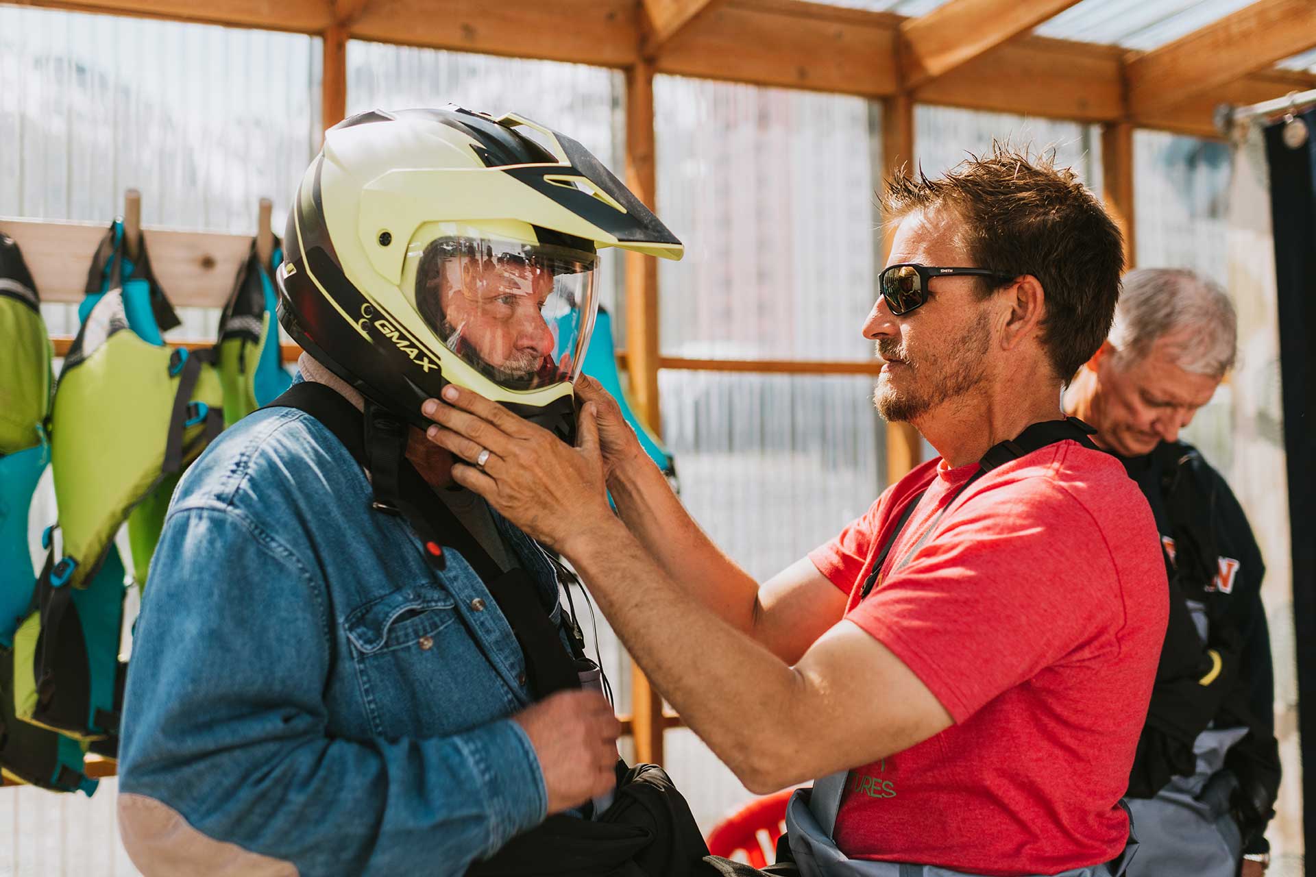Jetski Tour Guide Fitting Customer with Helmet