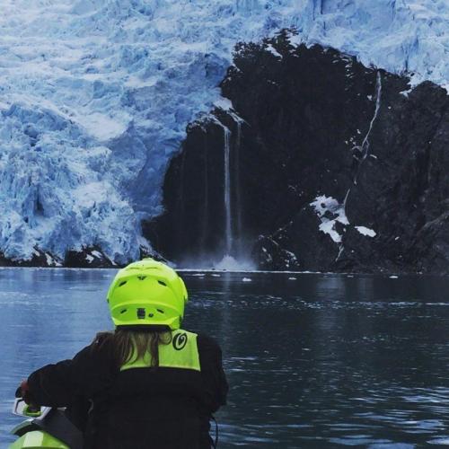 A client views a glacier and waterfall on a jet ski tour