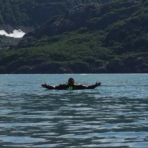 Client testing the drysuit in the cold waters of Alaskas Prince William Sound