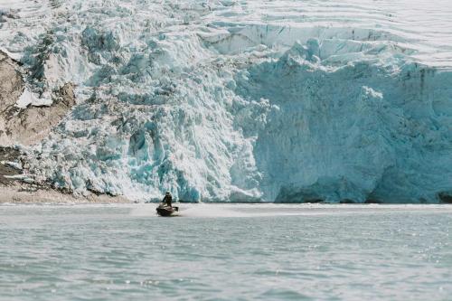 Jetski Riding in front of Large Glacier