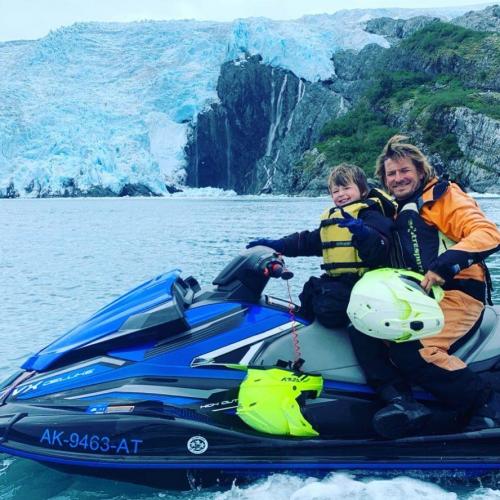Glacier Jetski Adventures owner Charlie and young son Mason on a jet ski in Blackstone Bay