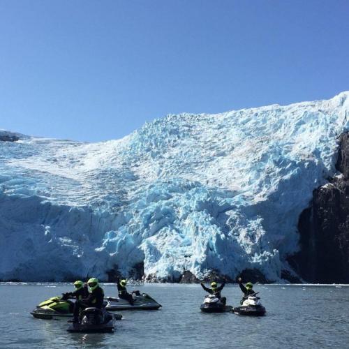 Group in front of a glacier on a jet ski adventure in Alaska