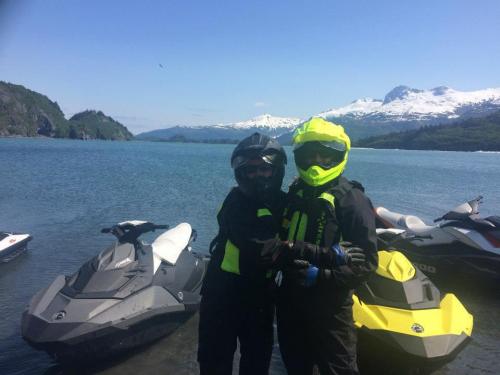 Happy jet ski tour customers on the shores of Blackstone Bay Alaska