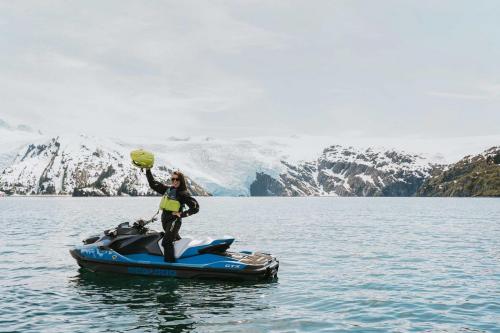 Woman on Jetski Posing with Glacier in Background